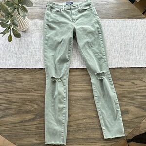 Distressed green jeans